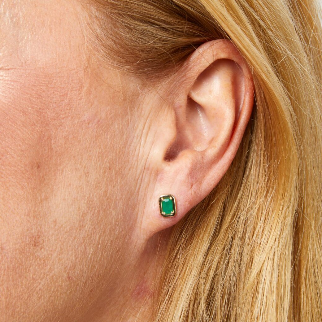 Art Deco Emerald Stud Earrings In 9ct Gold Introducing our gorgeous Emerald Stud Earrings In 9ct Gold. These Art Deco-inspired 9ct gold stud earrings feature striking green emeralds, perfect for elevating any outfit from everyday wear to special occasions.